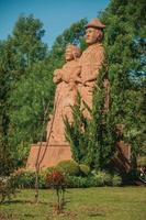 Nova Petropolis, Brazil - July 20, 2019. Sandstone sculpture of immigrant family in a garden at Sculpture Park Stones of Silence near Nova Petropolis. A lovely rural town founded by German immigrants. photo