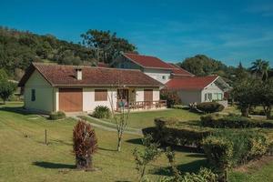 Bento Goncalves, Brazil - July 11, 2019. Modern country house with pathway and garden in a rural landscape near Bento Goncalves.