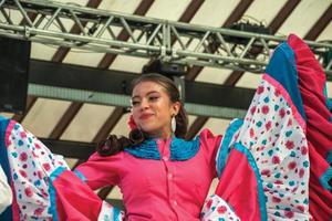 Nova Petropolis, Brazil - July 20, 2019. Colombian female folk dancer performing a typical dance on 47th International Folklore Festival of Nova Petropolis. A rural town founded by German immigrants. photo