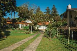 Gramado, Brazil - July 21, 2019. Entrance with lush garden and paved pathway in a house at Gramado. photo