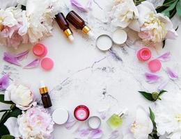 flat lay composition with peony flowers and natural cosmetic photo