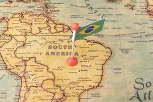 Brazil is marked with a flag on the map. Flag of Brazil on the world map. photo