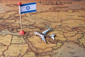la bandera de israel y el avión en el mapa mundial. foto