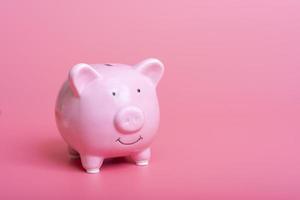 High-angle close-up view of cute piggy bank with copy space on pink background