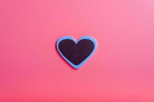 Heart on a pink background in the middle. The concept of Valentine's day. photo