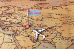 Flag of Azerbaijan and plane on the world map. photo