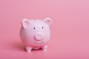 High-angle close-up view of cute piggy bank with copy space on pink background photo