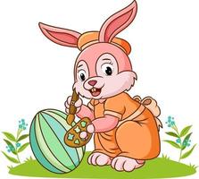 The cute rabbit is coloring the ester egg vector