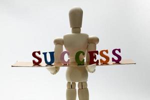 Success and wooden man. photo