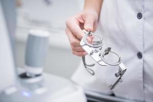 La doctora sostiene en sus manos las lentes de prueba ópticas para evaluar la visión. concepto medico foto