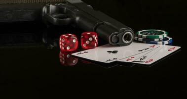 Poker chips, cards and a gun on a black background. The concept of gambling and entertainment. Casino and poker photo