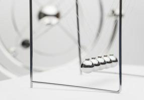 balancing balls on a white background. business concept. Newtons Cradle photo