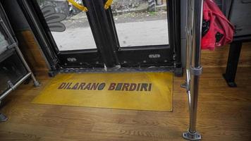 Semarang, Central Java, Indonesia, 2021 - Signs are prohibited from standing in front of the public transportation door, the bus rapid transit system photo