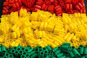 Plastic bricks of red, yellow and green photo