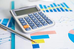 Calculator on chart and graph spreadsheet paper. Finance development, Banking Account, Statistics, Investment Analytic research data economy, Stock exchange trading, Business company concept. photo
