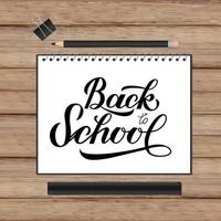 Back to school lettering hand written in a notebook. Wooden texture background and stationery. Vector template for advertising poster, logo design, banner, flyer, sign, greeting card, invitation, etc.