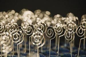 rows of shiny metal jewelry in a store for sale photo