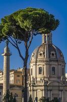 Traian column and church Santissimo Nome di Maria al Foro Traiano in Rome photo