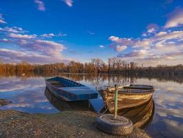 Old yellow boat on the lake photo