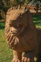 Nova Petropolis, Brazil - July 20, 2019. Sandstone sculpture of a lion in a green lawn at the Sculpture Park Stones of Silence near Nova Petropolis. A lovely rural town founded by German immigrants.