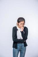 A woman coughing and covering her mouth with her hand