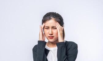 A sick woman with a headache and put her hand on her head photo