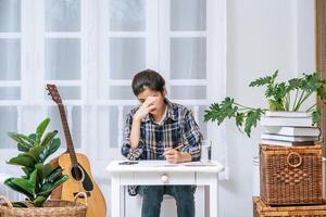 A woman sitting at a desk analyzes the document and is stressed. photo