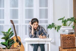 Women sit at the desk and use the phone to coordinate. photo