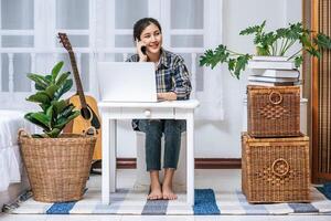 Women sit at the desk and use the phone to coordinate. photo