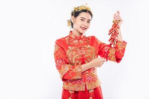 Woman wear Cheongsam suit smile to get Firecrackers from boss in chinese new year photo
