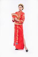 Woman wear Cheongsam suit and black shoe glad getting gift money from boss in chinese new year photo