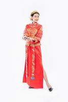 Woman wear Cheongsam suit and black shoe ready to give the gift money to relative photo