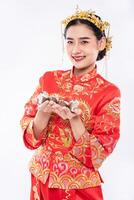 Woman wear Cheongsam suit and black shoe ready to give the gift money to relative photo