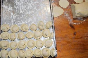 Woman sculpts dumplings at home photo