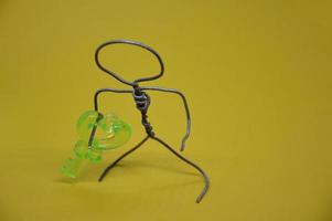 Human figure made of metal wire with an object photo