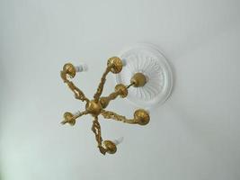 Bronze vintage chandelier on the ceiling photo