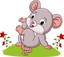 The mouse is sitting on the grass in the garden vector