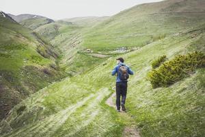 person hikes in mountains photo