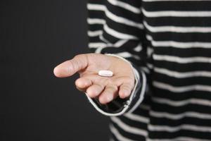 close up of medical pills on palm of child hand photo