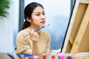 portrait of young asian girl painting photo