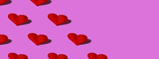 Red heart with a hard shadow on a pink background. Seamless patterns. Celebrating Valentine's Day copy space. Banner photo