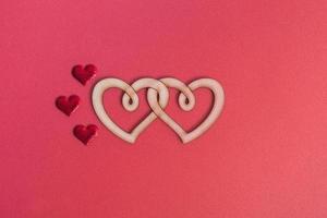 Wooden double heart on a red background copy space. Love concept, valentine's day photo