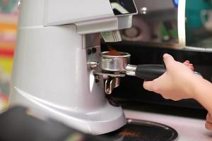 Coffee maker machine. Barista girl prepares coffee on the coffee machine photo