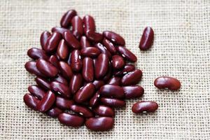 Red bean on sack background - Grains red kidney beans photo