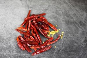 dried chillies on dark background - Red chili pepper seed photo