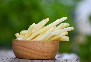 French fries in wooden bowl delicious Italian meny homemade ingredients on table nature green background - Tasty potato fries for food or snack