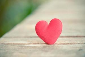 Holidays card Valentines day red heart on old wood for philanthropy concept - Hearts on a wooden background donate help give love take care photo