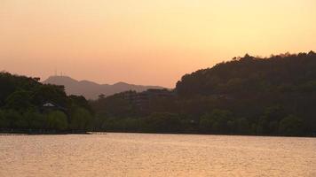The beautiful lake landscapes in the Hangzhou city of the China in spring with the sunset sunlight photo