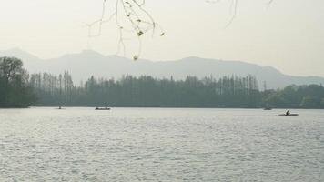 The beautiful lake landscapes in the Hangzhou city of the China in spring with the peaceful lake and fresh green mountains photo