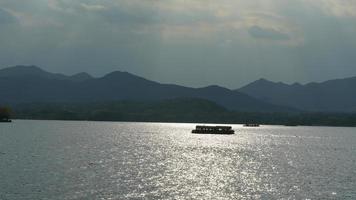 The beautiful lake landscapes in the Hangzhou city of the China in spring with the peaceful lake and fresh green mountains photo